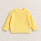 The Everyday Chunky Knit Sweater in Butter Yellow, laid flat on ivory linen