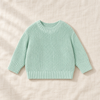 The Everyday Chunky Knit Sweater in Mint, laid flat on ivory linen