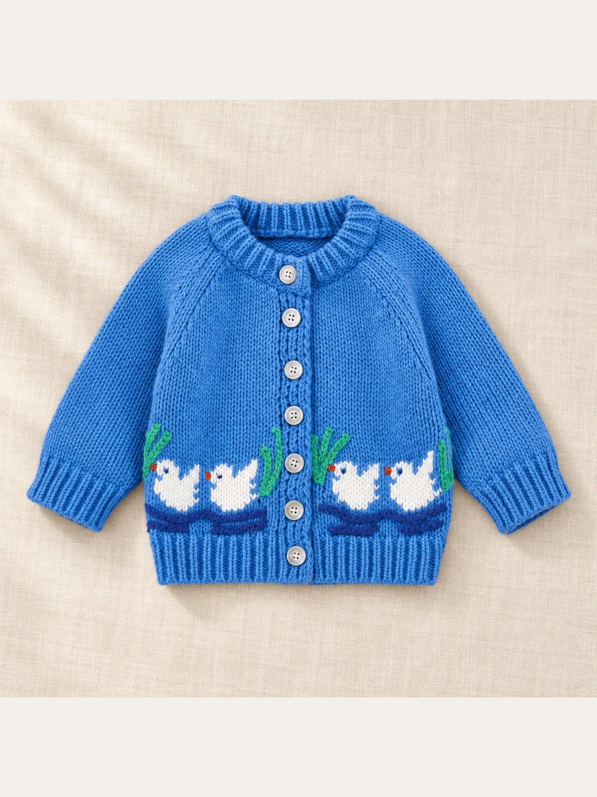 The Little Duck Knit Cardigan on ivory linen