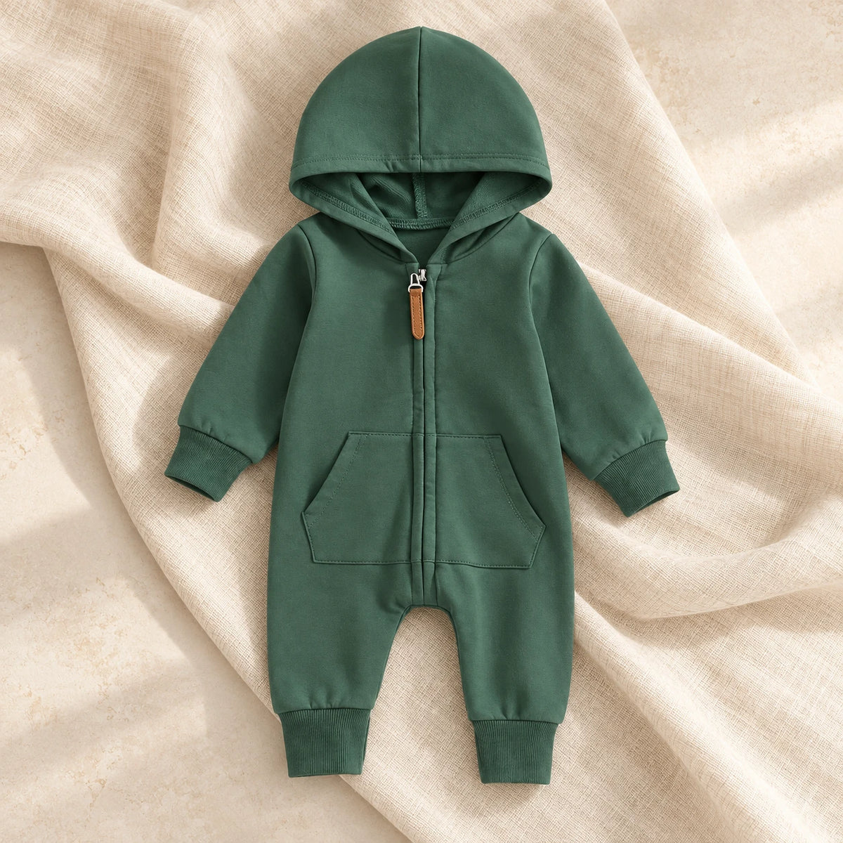 The Hooded Zip Baby Romper studio photograph on ivory linen