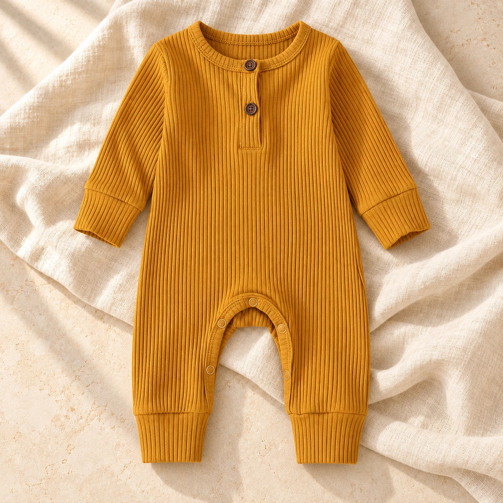 Mustard ribbed baby romper on warm ivory linen