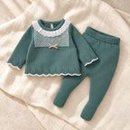 Deep sage knit sweater and footed leggings set on ivory linen