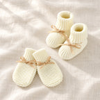 The Newborn Knit Wardrobe — Ivory Ribbon, Booties & Mittens in boutique studio photograph