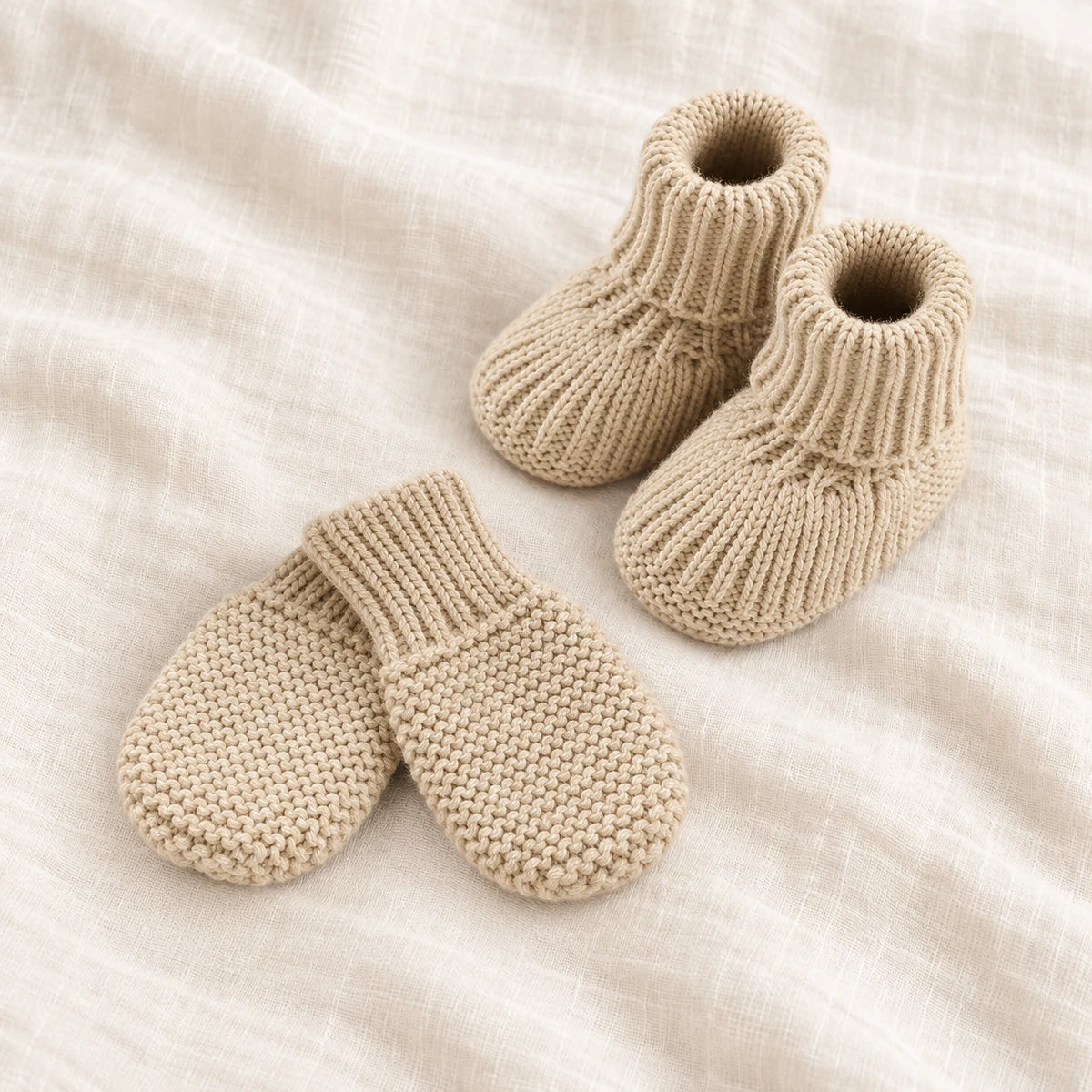 The Newborn Knit Wardrobe — sand plain booties and mittens on ivory linen