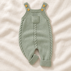 The Pocket Knit Baby Dungarees on ivory linen