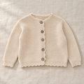 The Scallop-Edge Knit Cardigan on ivory linen