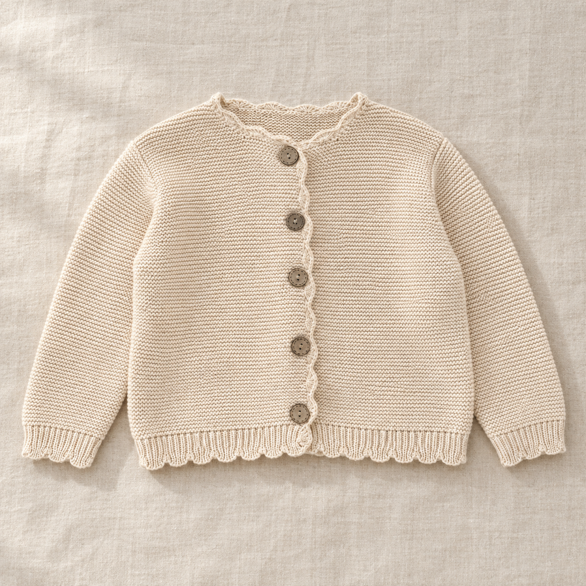 The Scallop-Edge Knit Cardigan on ivory linen