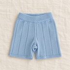 The Knit Polo & Shorts Separates — Blue Shorts, laid flat on ivory linen