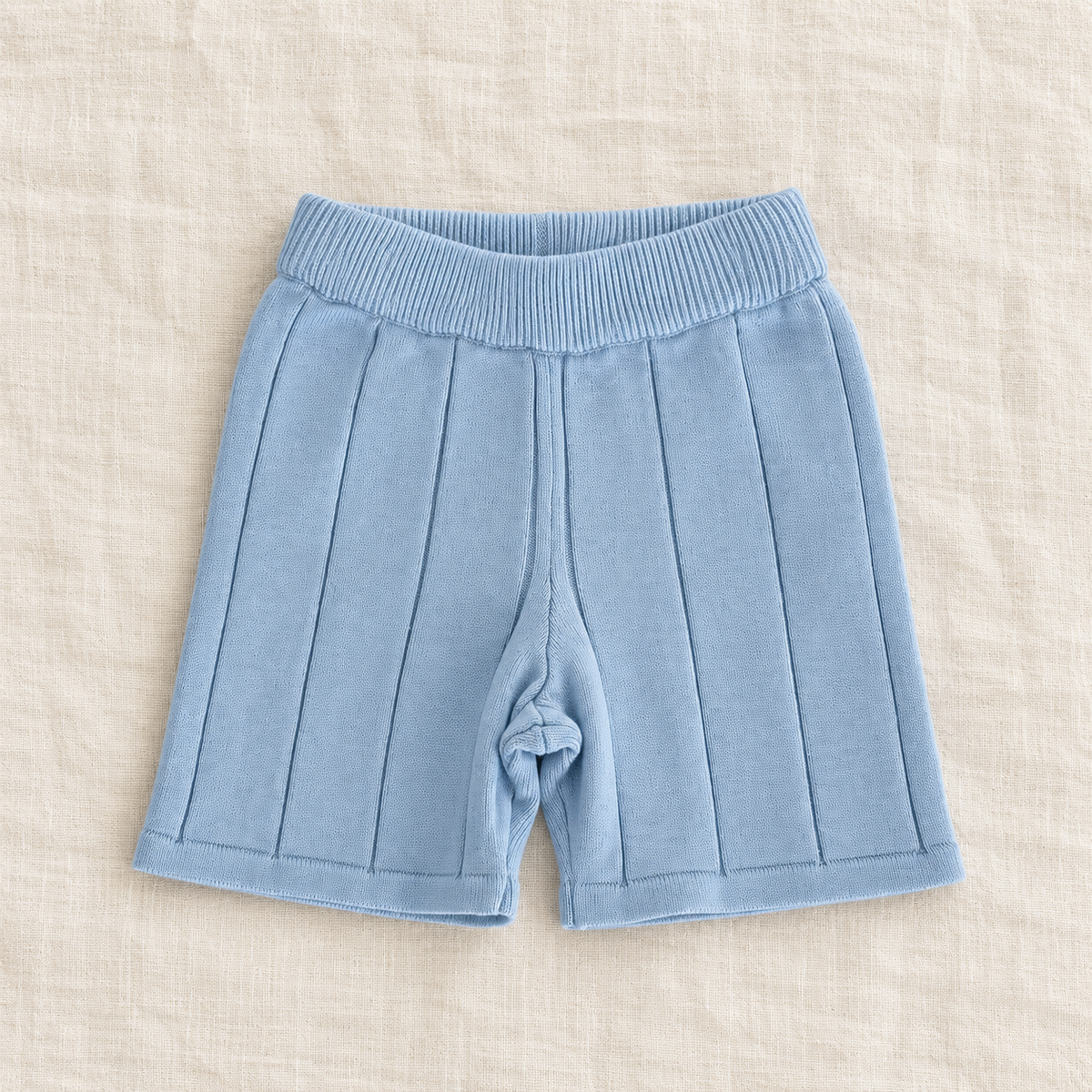 The Knit Polo & Shorts Separates — Blue Shorts, laid flat on ivory linen