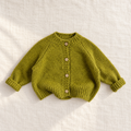 The Cozy Button Knit Cardigan — Green, laid flat on ivory linen