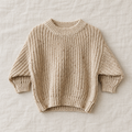The Relaxed Rib Knit Sweater — Apricot Dots, laid flat on ivory linen