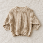 The Relaxed Rib Knit Sweater — Apricot Dots, laid flat on ivory linen