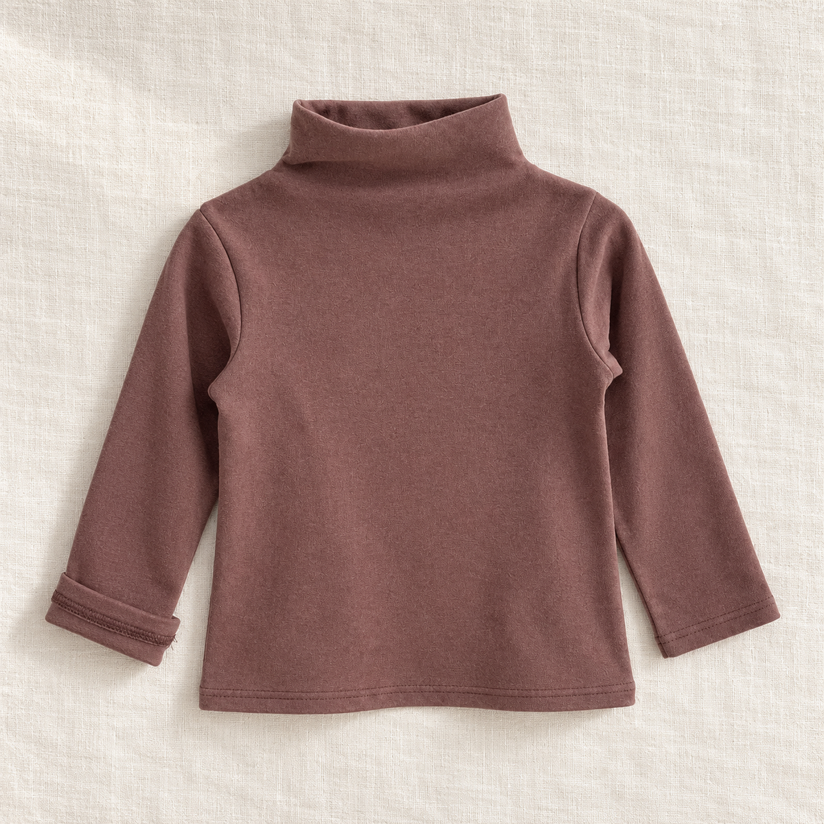 The High-Neck Layering Top — Brown, laid flat on ivory linen