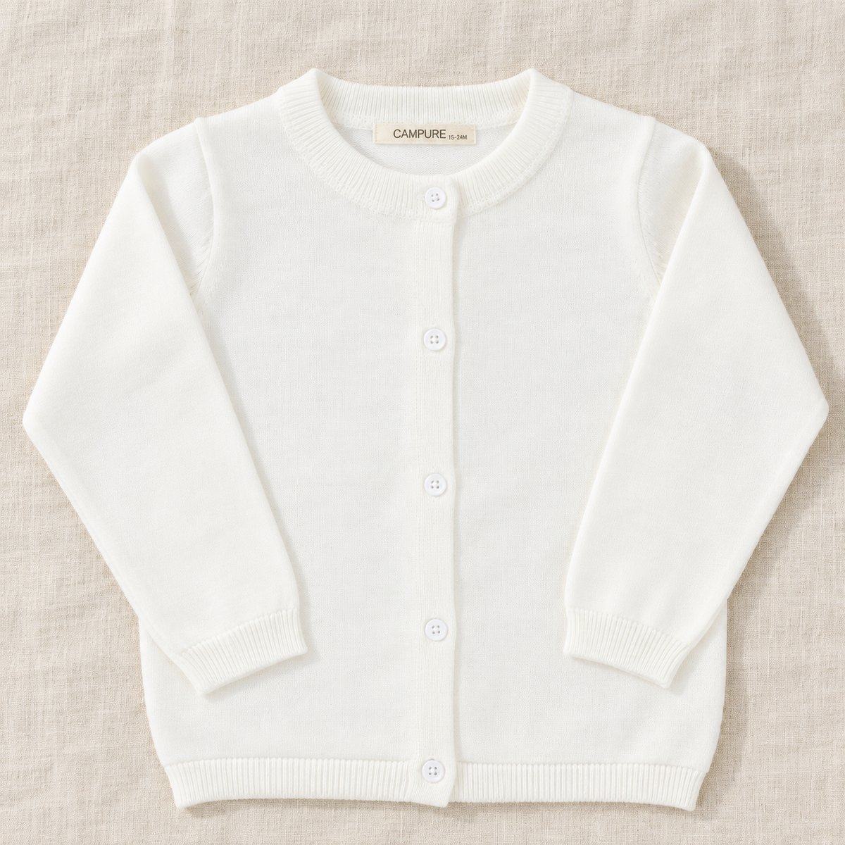 The Everyday Fine Knit Cardigan — White, laid flat on ivory linen