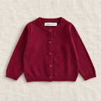 The Everyday Fine Knit Cardigan — Dark Red, laid flat on ivory linen