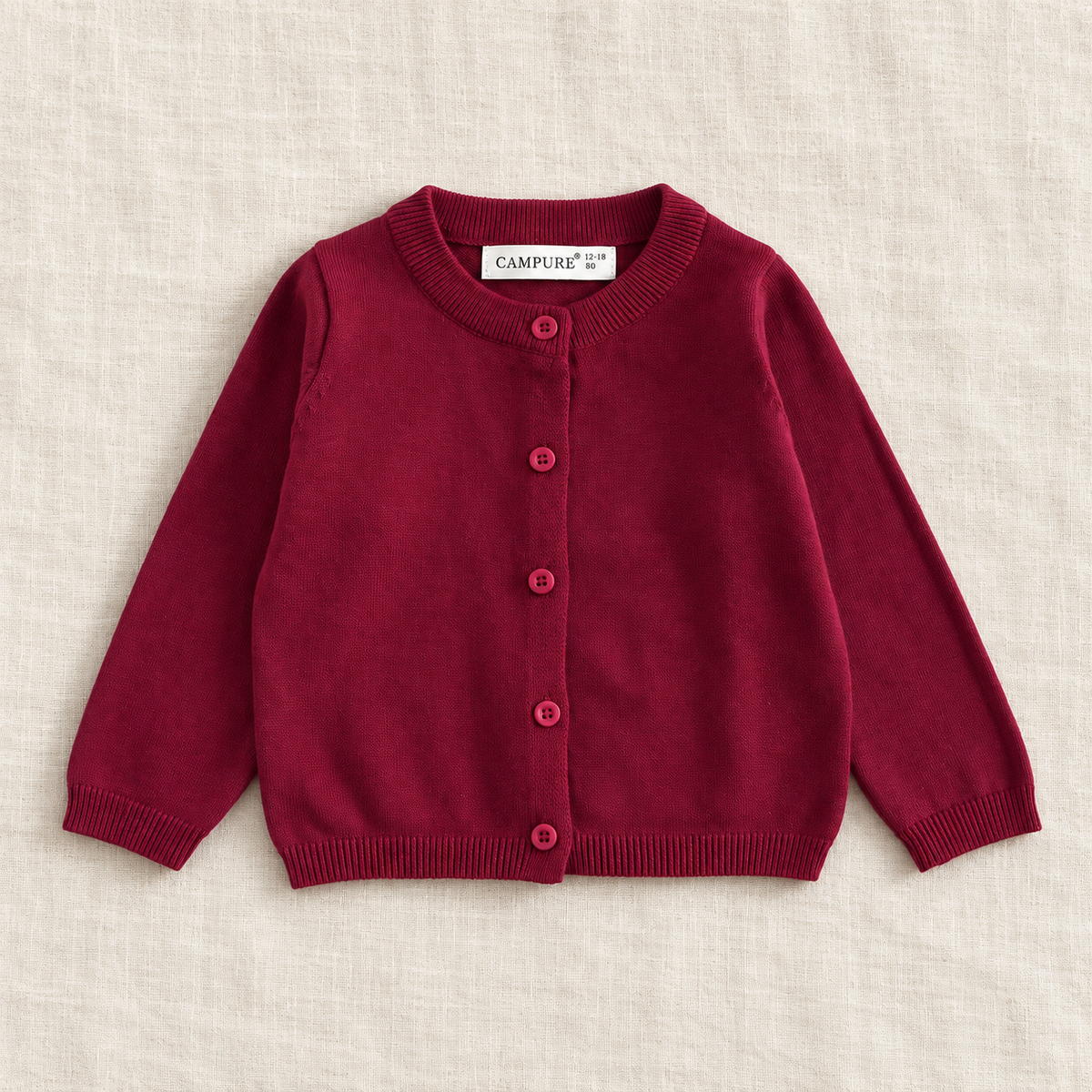 The Everyday Fine Knit Cardigan — Dark Red, laid flat on ivory linen