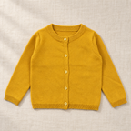 The Everyday Fine Knit Cardigan — Ginger, laid flat on ivory linen