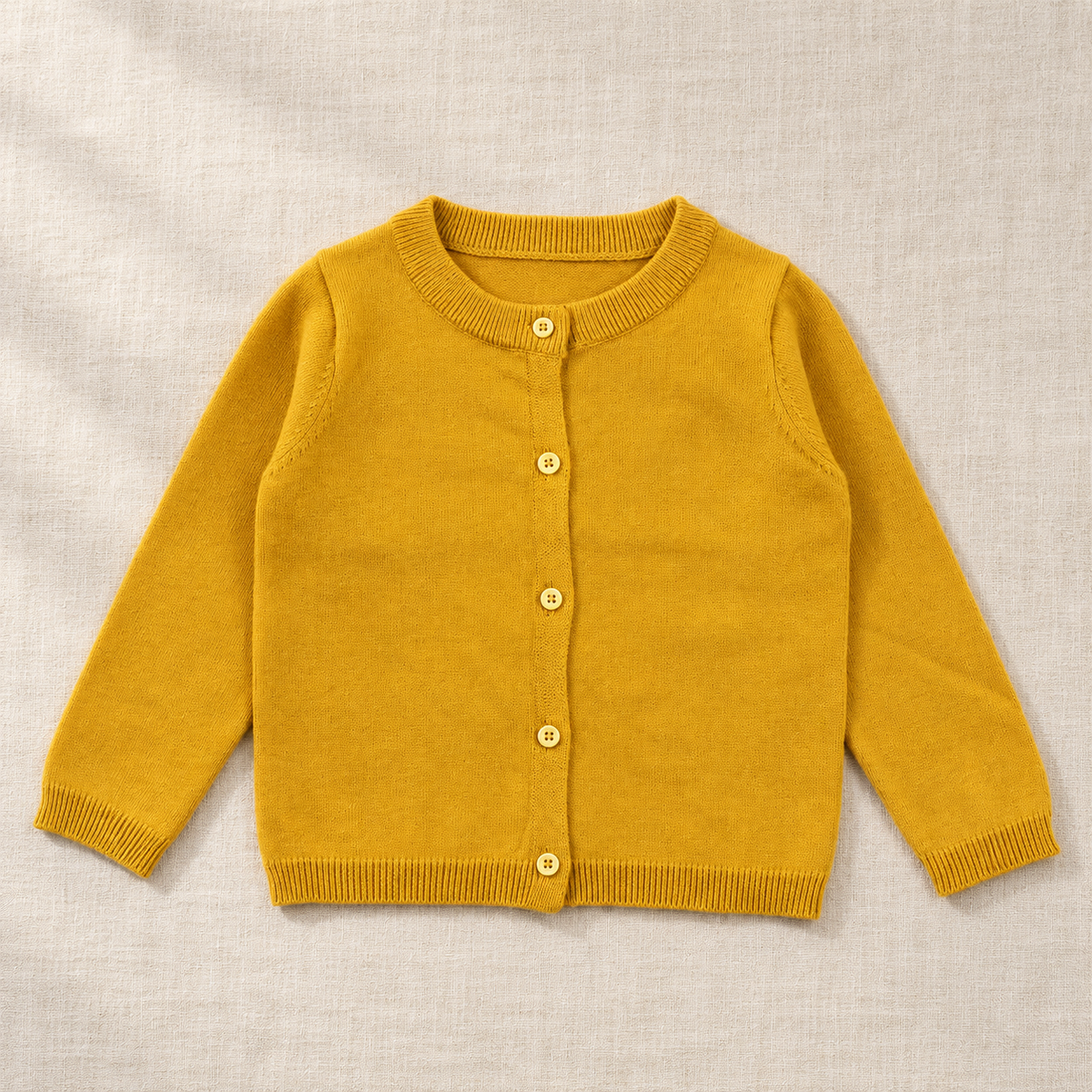 The Everyday Fine Knit Cardigan — Ginger, laid flat on ivory linen