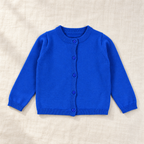 The Everyday Fine Knit Cardigan — Blue, laid flat on ivory linen