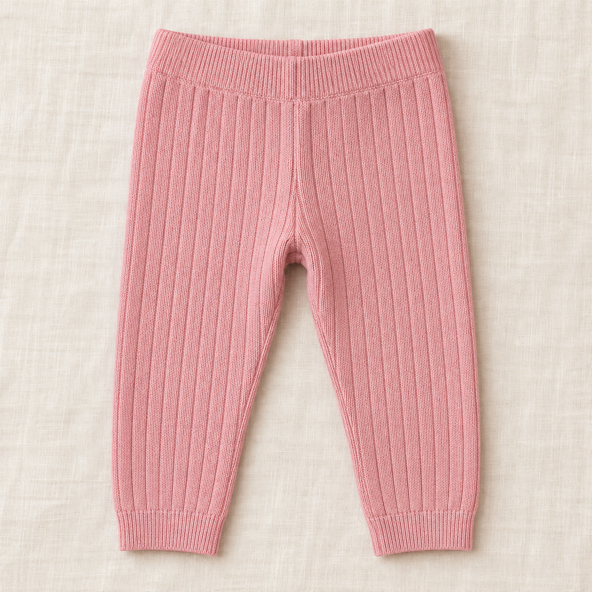 The Everyday Rib Knit Leggings — Pink, laid flat on ivory linen