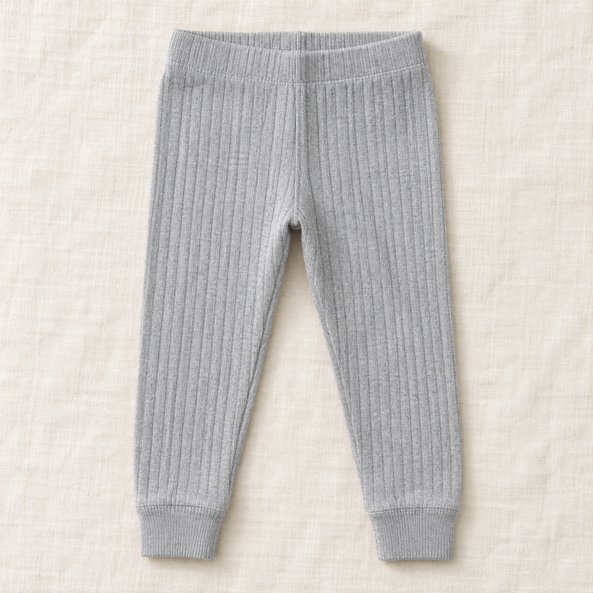 The Everyday Rib Knit Leggings — Light Gray, laid flat on ivory linen