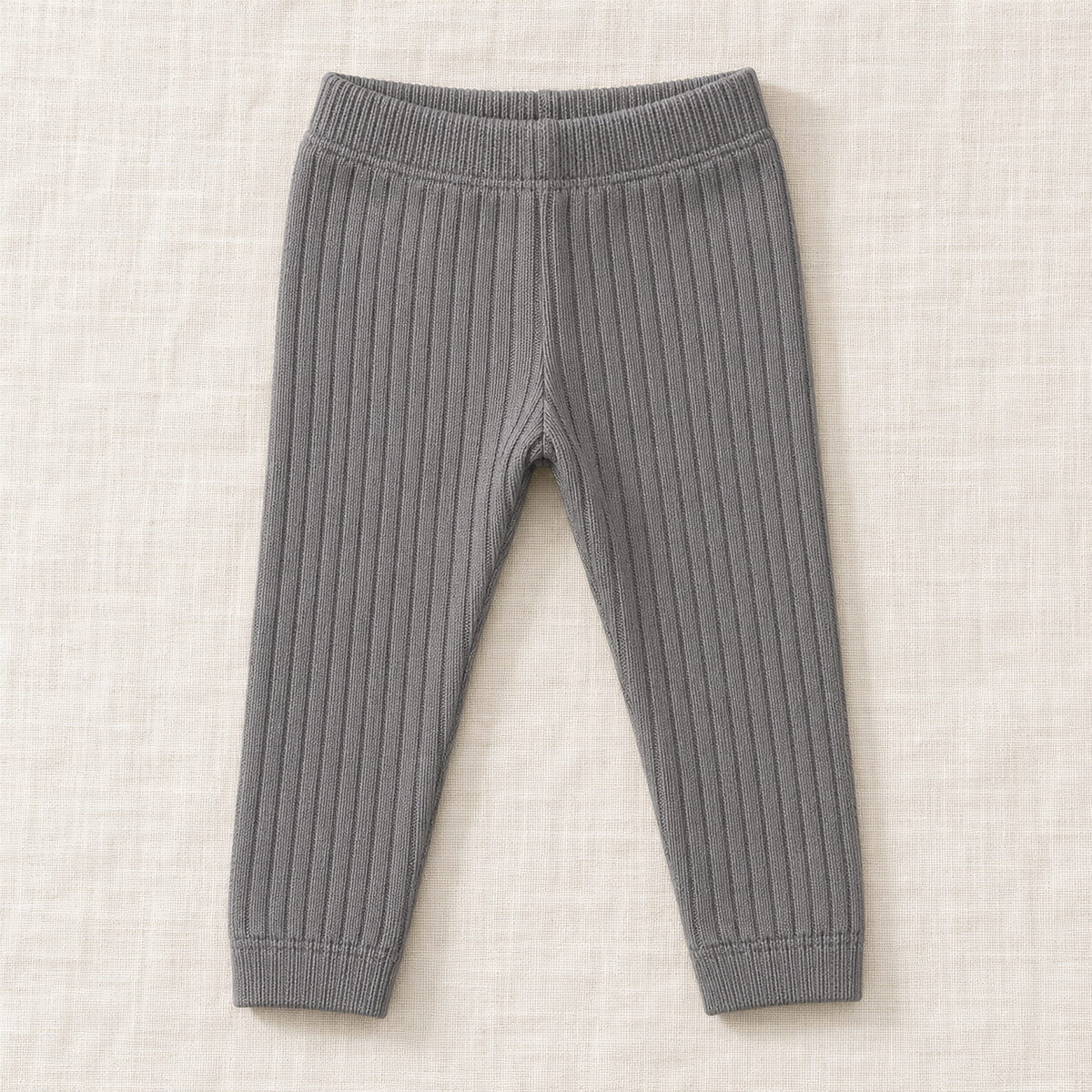 The Everyday Rib Knit Leggings — Dark Grey, laid flat on ivory linen