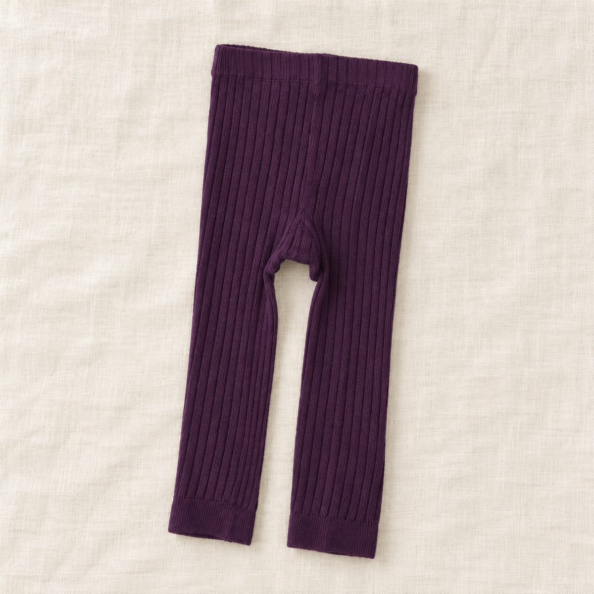 The Everyday Rib Knit Leggings — Purple, laid flat on ivory linen