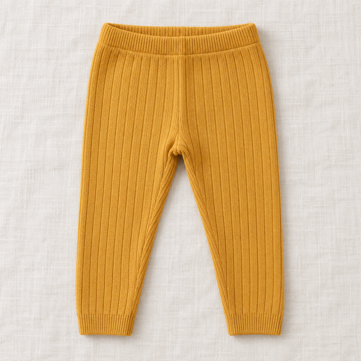 The Everyday Rib Knit Leggings — Yellow, laid flat on ivory linen