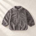 The Plush Zip Jacket — Gray, laid flat on ivory linen