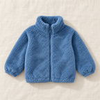 The Plush Zip Jacket — Denim Blue, laid flat on ivory linen