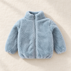 The Plush Zip Jacket — Light Blue, laid flat on ivory linen