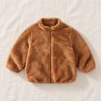 The Plush Zip Jacket — Caramel, laid flat on ivory linen