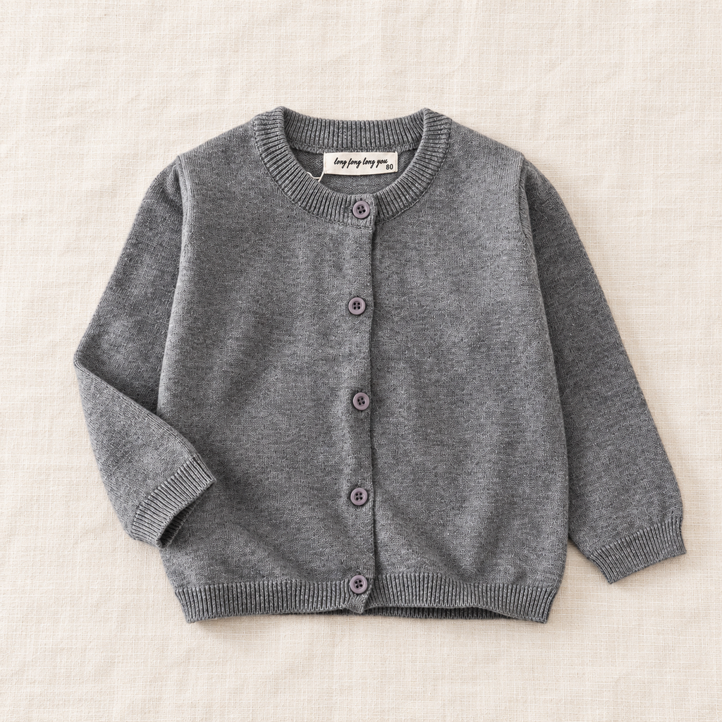 The Simple Button Knit Cardigan — Gray, laid flat on ivory linen