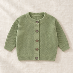 The Ribbed Button Knit Cardigan — Pea Green, laid flat on ivory linen