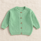 The Ribbed Button Knit Cardigan — Green, laid flat on ivory linen