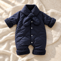 Navy blue padded baby romper with plush collar on ivory linen