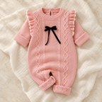The Blush Knit Baby Romper studio photograph on ivory linen