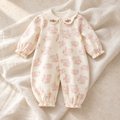 The Botanical Cotton Baby Romper studio photograph on ivory linen