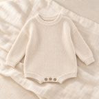 The Button Knit Baby Romper studio photograph on ivory linen