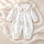 The Collared Cotton Baby Romper studio photograph on ivory linen