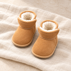 The Cozy Velcro Baby Boots studio photograph on ivory linen