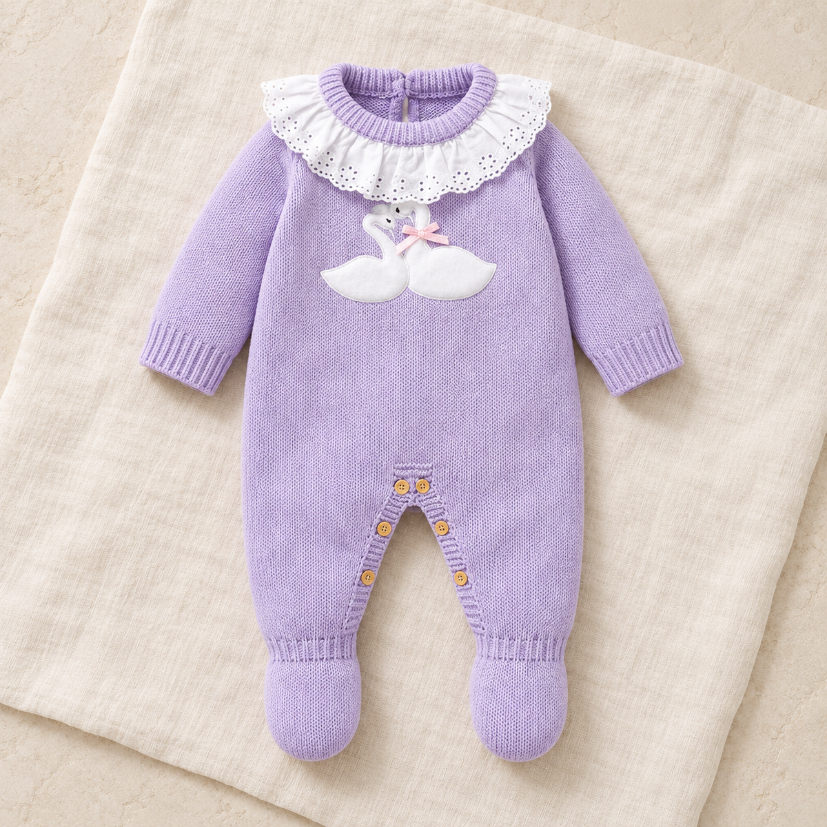 The Goose Knit Baby Romper studio photograph on ivory linen