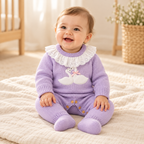 Baby wearing The Goose Knit Baby Romper in a warm nursery