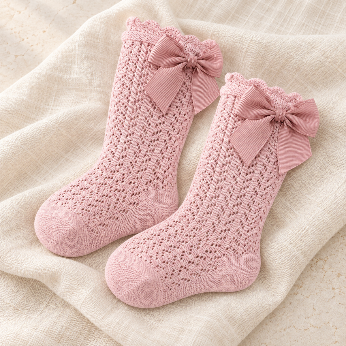 The Lace Bow Baby Socks studio photograph on ivory linen