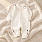 The Printed Cotton Baby Romper studio photograph on ivory linen