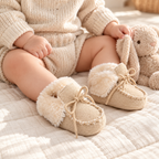 Baby wearing The Soft-Sole Baby Snow Boots in a warm nursery
