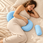 Blue quilted wedge pillow supporting a pregnant woman's belly and back